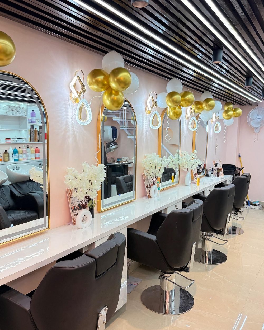 Salon interior with styling stations at Magnify By Varsha
