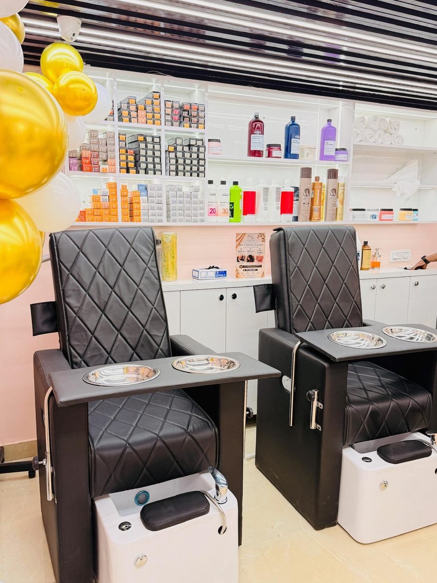 Pedicure and styling chairs at Magnify By Varsha salon